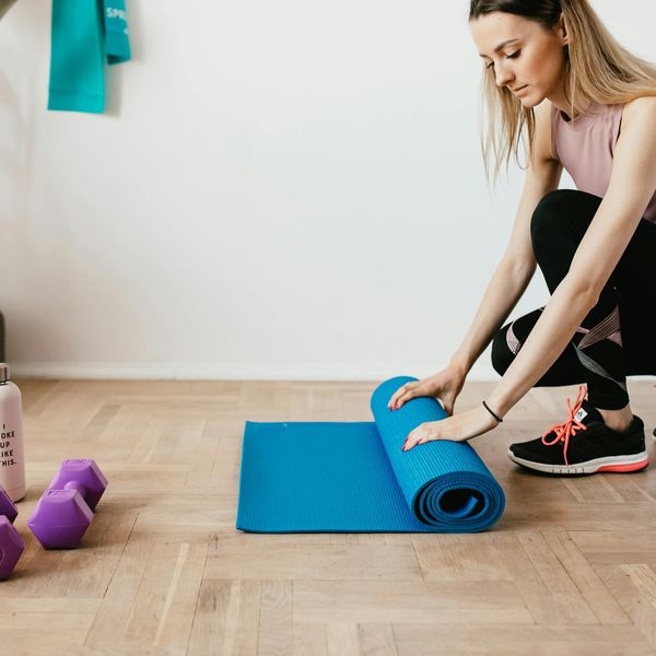 Comfortable workout clothes and a water bottle placed neatly on a floor.
